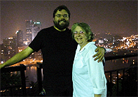 Fr Ivan Chirovsky and his wife Maria with Pittsburgh at night in the background.