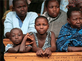 Children listen to Eddie at the Kasese conference.